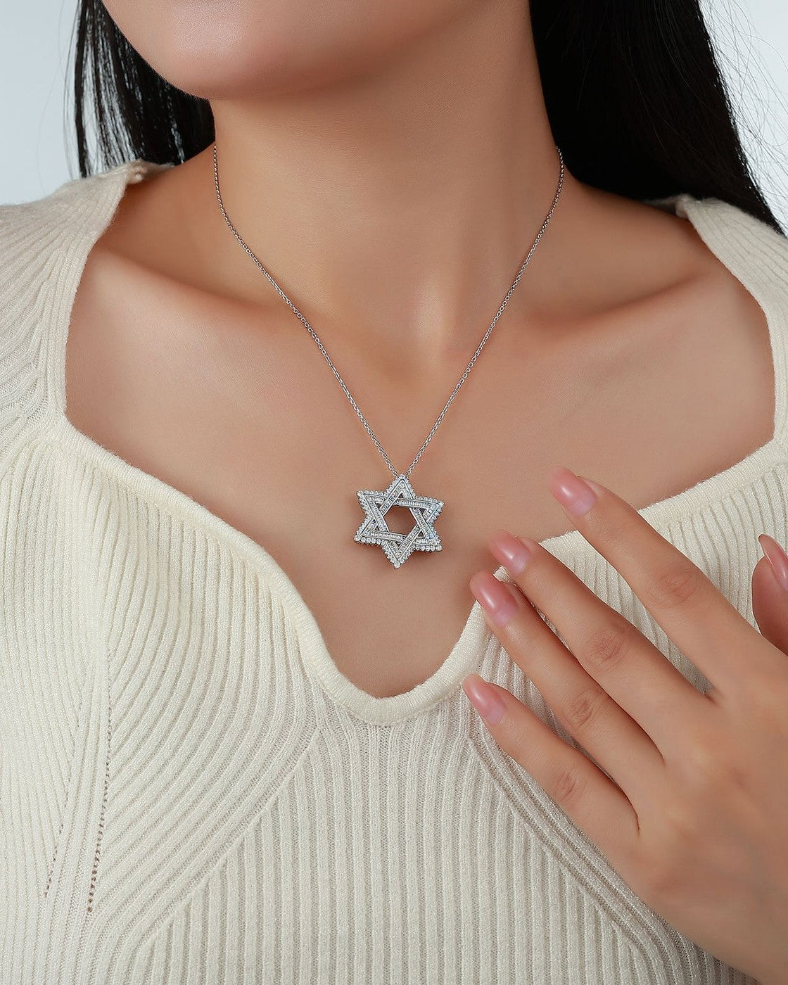 Woman wearing a pavé Star of David necklace