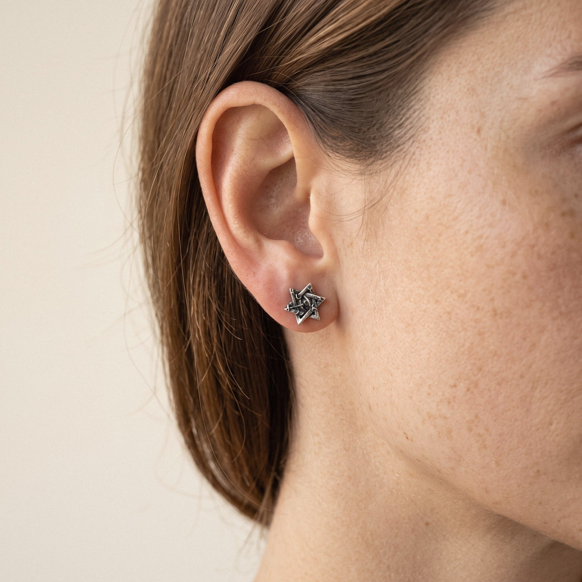 Star of David Stud Earrings in 925 Sterling Silver, Oxidized - worn on the ear